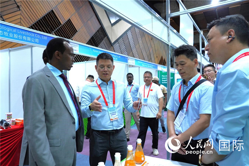 博览会现场，本地客商在与中国参展商交流。人民网记者黄炜鑫摄